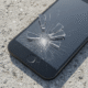 Cracked smartphone screen on concrete